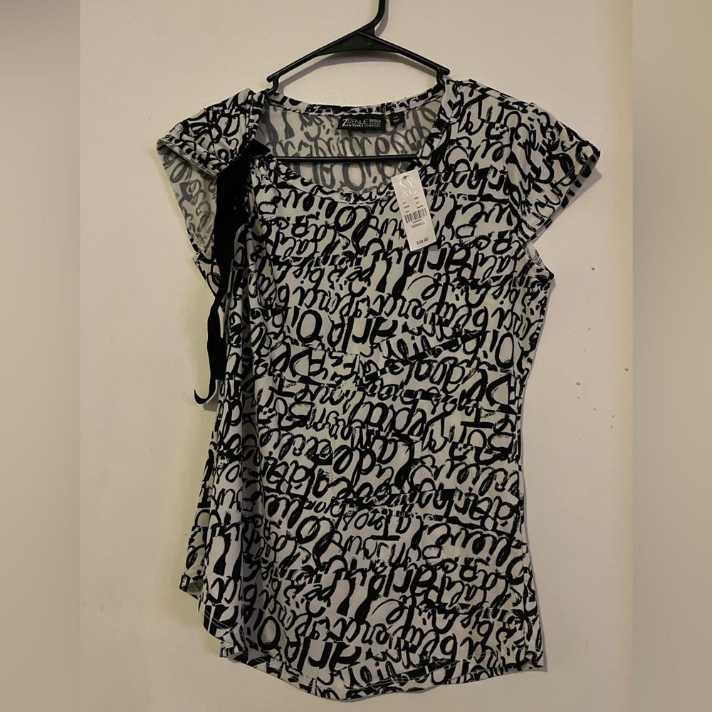 Nice outfit. Top is an XS, and, pants are 00 Petite.